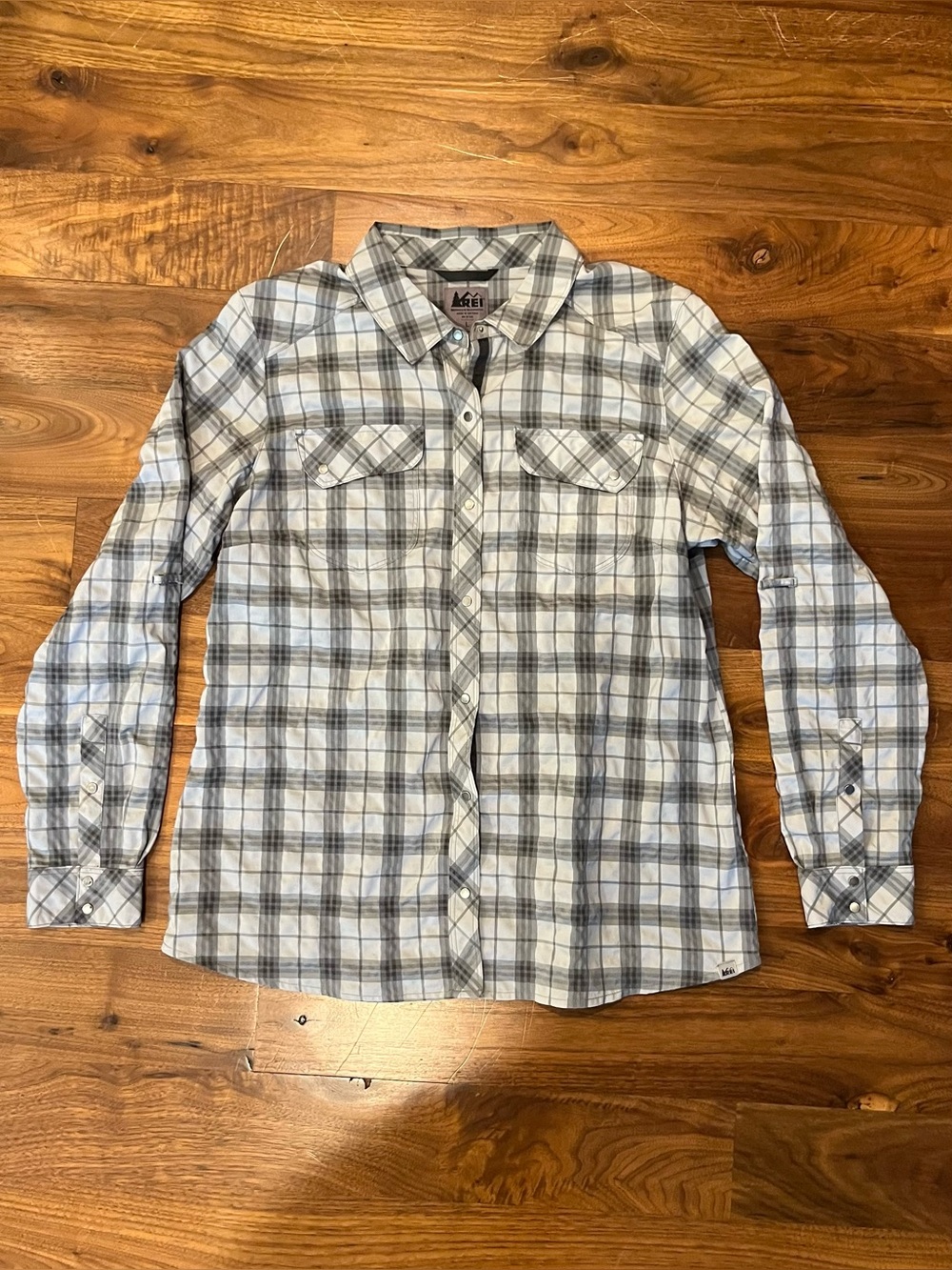 Long-sleeved grey plaid shirt by REI in women’s size large.